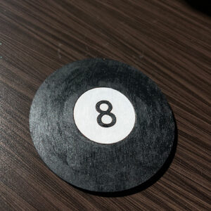 photography of a black and white 8-ball wooden coaster